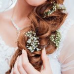 woman holding her hair with flower