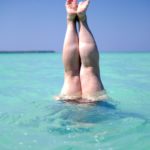 a person laying on their back in the water